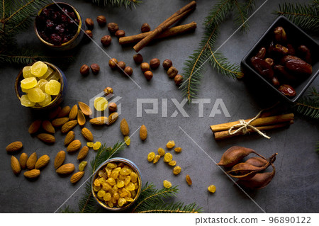 Ingredients for traditional Christmas cake - nuts, dried fruits, dates, cinnamon. Christmas bakery background. Flat lay. Copy space. 96890122