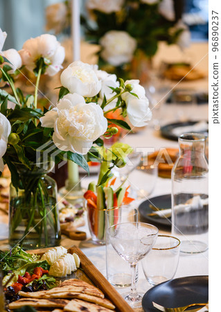 Beautiful table event setting with peony flowers 96890237