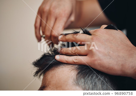 hairdresser does haircut for man in barber shop hairdresser does haircut for man in barber shop 96890758