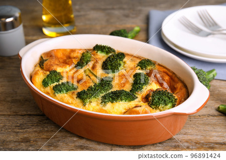 Tasty broccoli casserole in baking dish on wooden table Tasty broccoli casserole in baking dish on wooden table 96891424