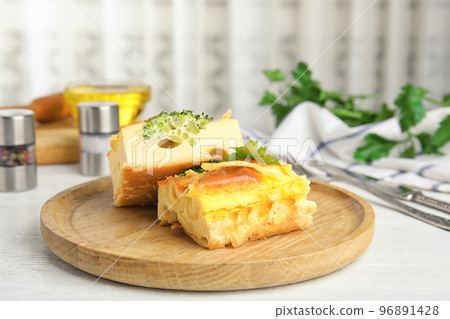 Tasty broccoli casserole served on white wooden table indoors Tasty broccoli casserole served on white wooden table indoors 96891428