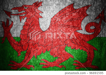 Closeup of grunge Welsh flag. Dirty Wales flag on a metal surface Closeup of grunge Welsh flag. Dirty Wales flag on a metal surface 96891595