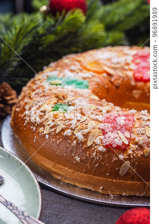 Roscon is a traditional Spanish Christmas pastry cake surrounded by spruce branches Roscon is a traditional Spanish Christmas pastry cake surrounded by spruce branches 96891989