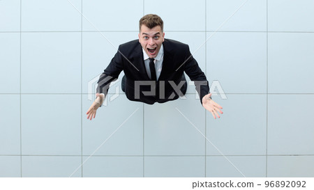Celebrating success. Low angle view of excited young businessman keeping arms 96892092