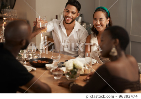 Wine, toast and party with friends at table of dining room for new year celebration, festive and social gathering. Drink, dinner and cheers with group of people at home for reunion, holiday and event 96892474