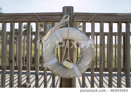 Destin, Florida- White lifebuoy hanging on a handrails of a boardwalk 96893064