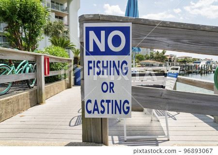 No fishing or casting sign on a wood railings at Destin, Florida 96893067