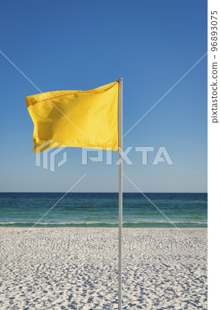 Yellow flag on a pole at the beach in Destin, Florida 96893075