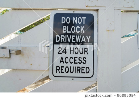 Destin, Florida- Close-up of a sign with Do Not Block Driveway 24 Hour Access Required 96893084