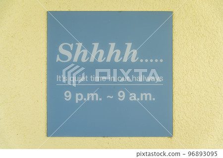 Destin, Florida- Sign on a wall with Shhhh... It's quiet time in our hallways- 9 p.m- 9 a.m 96893095
