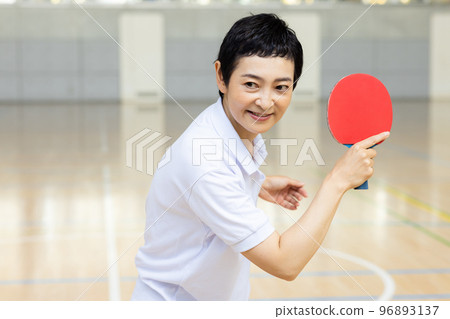 A woman enjoying table tennis A woman enjoying table tennis 96893137