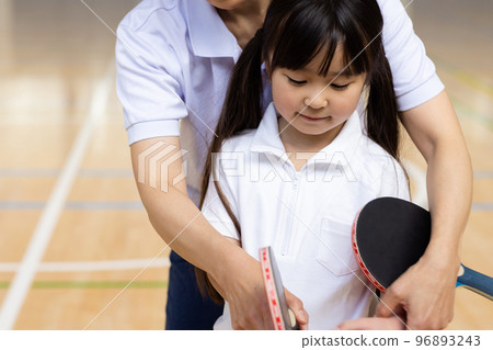 A woman enjoying table tennis 96893243