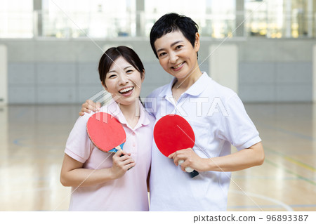 A woman enjoying table tennis A woman enjoying table tennis 96893387