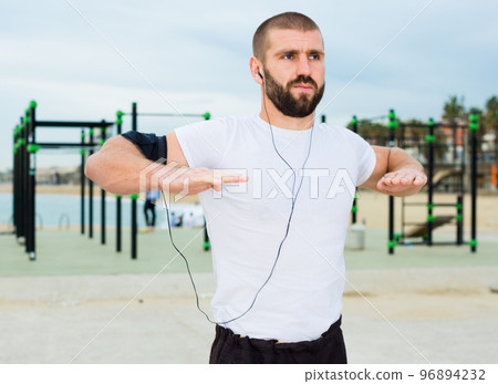 Warming up young man 96894232