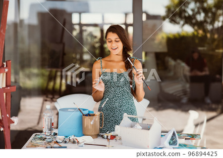 Young beautiful female artist with tools posing for camera 96894425