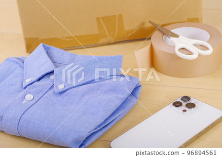 Clothing and cardboard boxes. An image of selling unwanted items and tidying up. Clothing and cardboard boxes. An image of selling unwanted items and tidying up. 96894561