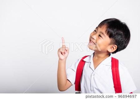 Asian toddler smiling happy wear student thai uniform red pants keeps pointing finger at copy space in studio shot isolated on white background, Portrait little children boy preschool, Back to school Asian toddler smiling happy wear student thai uniform red pants keeps pointing finger at copy space in studio shot isolated on white background, Portrait little children boy preschool, Back to school 96894697