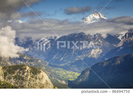 Misty Eiger above Grindelwald valley, Snowcapped Bernese Swiss alps, Switzerland Misty Eiger above Grindelwald valley, Snowcapped Bernese Swiss alps, Switzerland 96894750