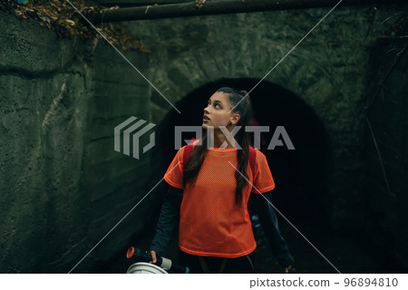 A young woman digger comes out of a rain collector 96894810