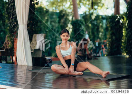Young woman practicing yoga. Performs an exercise 96894826