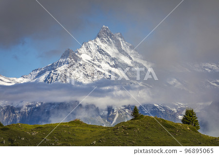 Misty Mountain above Grindelwald, Snowcapped Bernese Swiss alps, Switzerland Misty Mountain above Grindelwald, Snowcapped Bernese Swiss alps, Switzerland 96895065