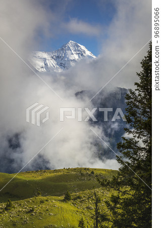 Misty Mountain above Grindelwald, Snowcapped Bernese Swiss alps, Switzerland Misty Mountain above Grindelwald, Snowcapped Bernese Swiss alps, Switzerland 96895066