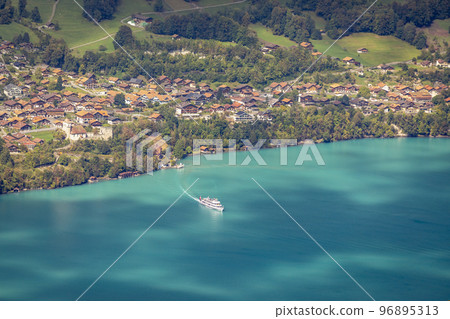 Aerial view of Swiss Alps and Lake Brienz with ferry boat at sunset, Interlaken 96895313