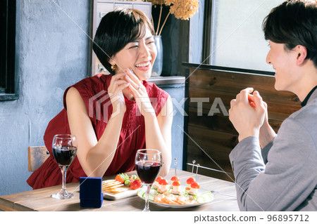 A couple, a woman who received a ring 96895712