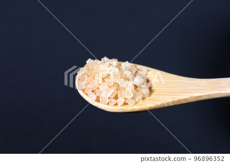 Coarse sugar in a spoon 96896352