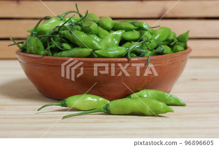 Bowl of Fresh Green Aji Limo Chili Peppers on Wooden Table Bowl of Fresh Green Aji Limo Chili Peppers on Wooden Table 96896605