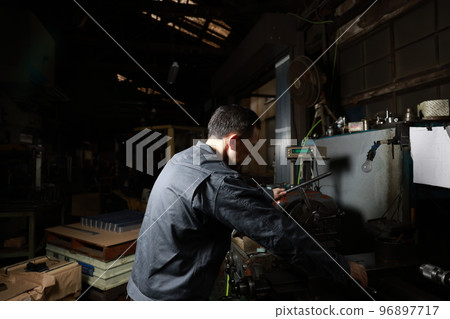 A metalworking craftsman in a rural town factory 96897717