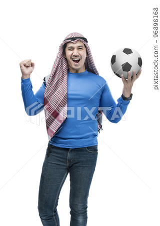 Asian man with keffiyeh standing while holding the ball with a happy expression Asian man with keffiyeh standing while holding the ball with a happy expression 96898168
