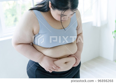 woman looking at belly woman looking at belly 96898268