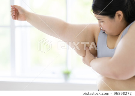 woman looking at arm woman looking at arm 96898272