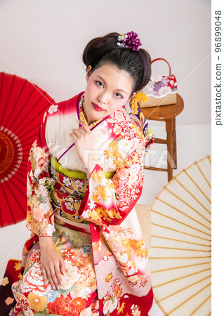 A woman wearing a long-sleeved kimono A woman wearing a long-sleeved kimono 96899048