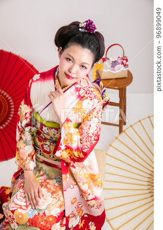 A woman wearing a long-sleeved kimono A woman wearing a long-sleeved kimono 96899049