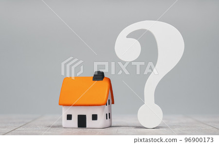 mortgage calculator or real estate business concept. Office desk with a white house and big question mark. Loan or insurance rate payments guidance support. Liability and risk 96900173