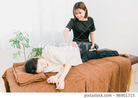 Asian woman who is a masseuse, therapist, chiropractor, and physical therapist who corrects the pelvis 96901715