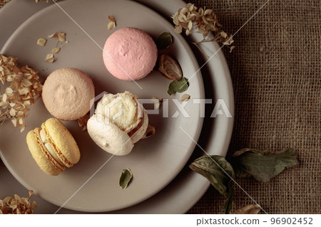 Delicious sweet colorful macaroons with dried flowers. 96902452