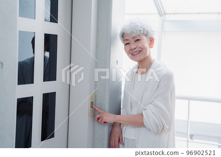 Senior woman using home elevator 96902521