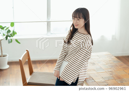 A young woman thinking about her new life in her new home 96902961