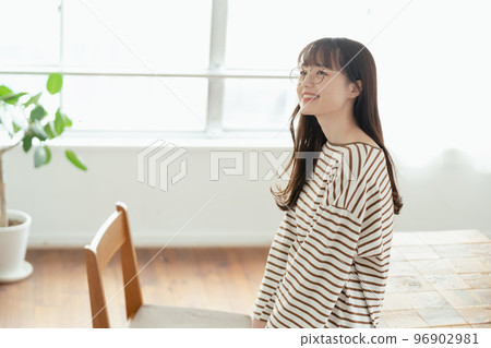 A young woman thinking about her new life in her new home 96902981