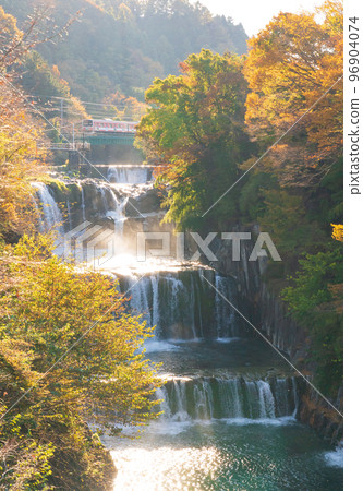 Fujikyu Line and Tahara Falls in autumn colors 96904074