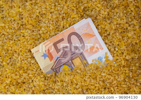 Euro bill paper money currency banknote in buckwheat porridge. The crisis in the market of grain crops, the rise in prices or production volumes of buckwheat Food and groceries shopping price increase Euro bill paper money currency banknote in buckwheat porridge. The crisis in the market of grain crops, the rise in prices or production volumes of buckwheat Food and groceries shopping price increase 96904130