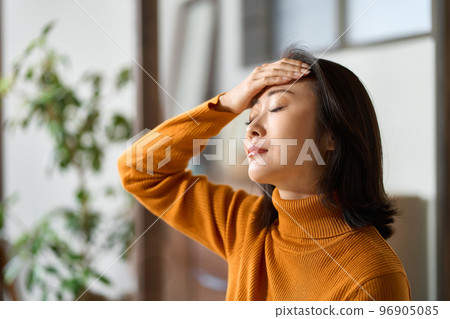 Asian woman taking a fever due to poor physical condition 96905085