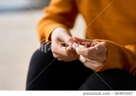 Hands of a woman playing with nails in stress 96905087