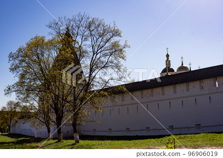 The outer wall of the Pafnuty-Borovsky Monastery with trees. Borovsk, Kaluga region, Russia The outer wall of the Pafnuty-Borovsky Monastery with trees. Borovsk, Kaluga region, Russia 96906019