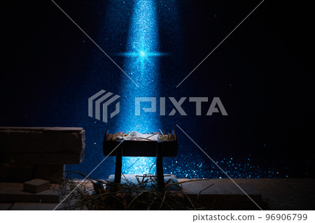 Nativity of Jesus, empty manger at night with bright lights. 96906799