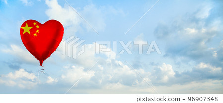 Flag of China on heart-shaped balloon against sky clouds 96907348