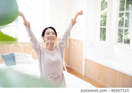 A woman stretching in the pleasant morning sun Copy space on the right 96907524